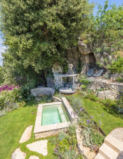 Aerial view of the stone pool and plantings in the garden of Villa Hinn