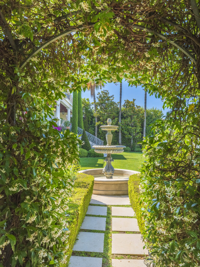 Fontaine en pierre dans un jardin réalisé par Adonis Paysages