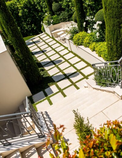 Geometric pathway lined with cypress trees in a structured garden