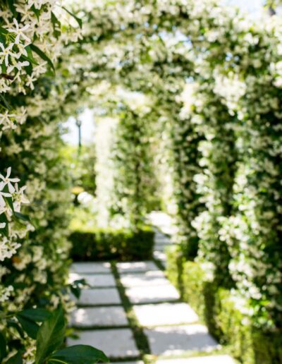 Jasmine-covered garden arches in a Florentine-inspired garden