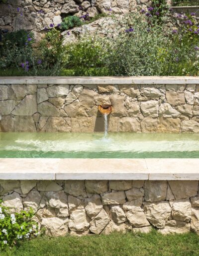 Spout feeding the stone pool in the garden of Villa Hinn