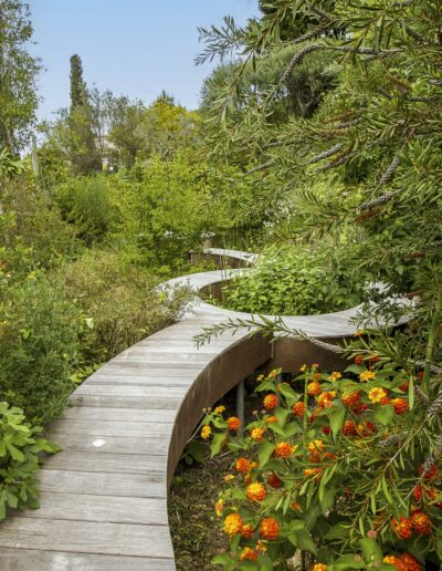 Staircase opening onto a colorful garden with stone retaining wall