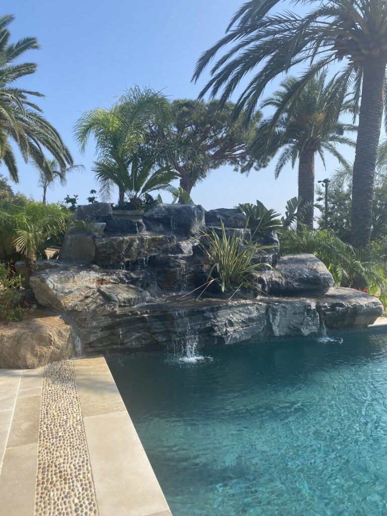 Stone waterfall flowing into a pool