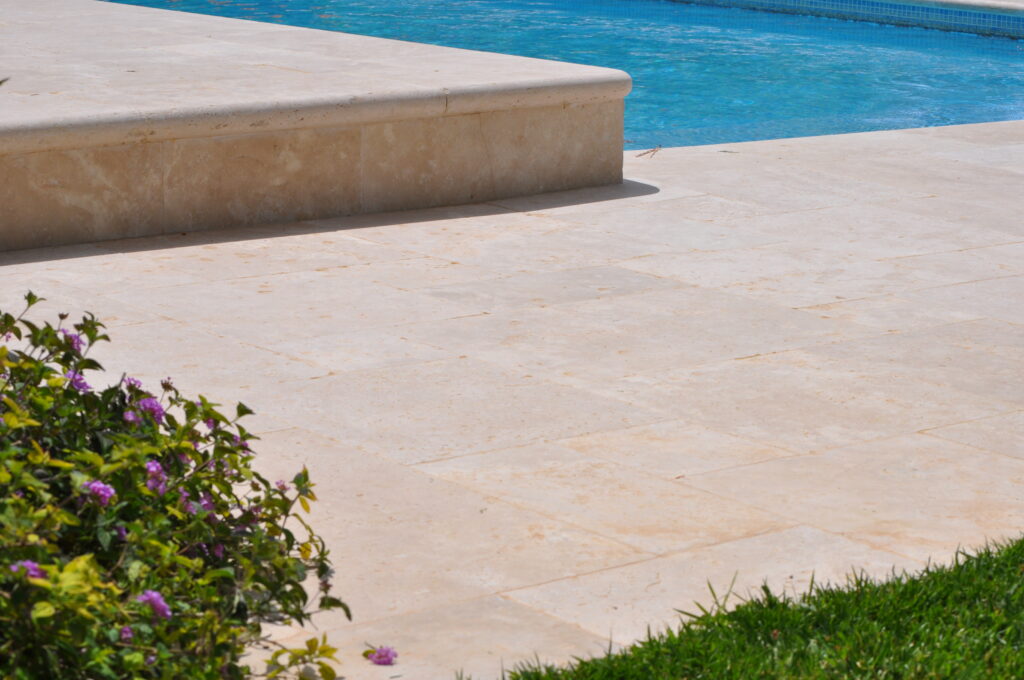 Details of a travertine terrace around a pool
